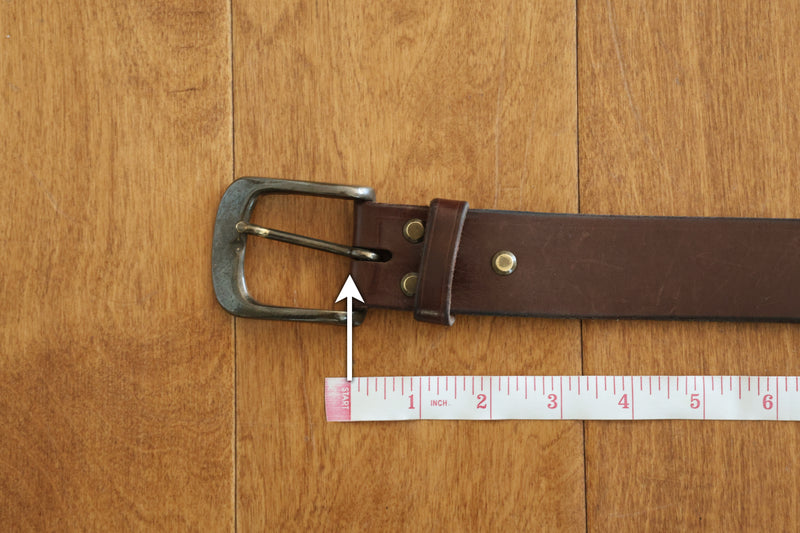 Measure from the end of the leather nearest the buckle. Do not include the buckle itself.