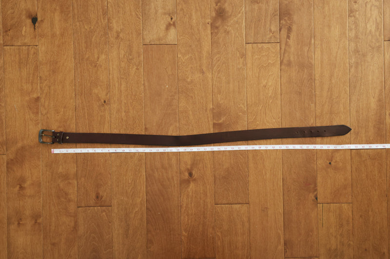 Lay your current belt flat on a table or floor.